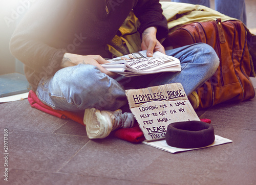 young unemployed man panhandling on the street photo
