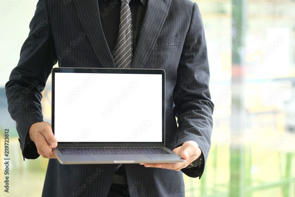Businessman holding a blank screen laptop. Businessman holding a blank screen laptop.