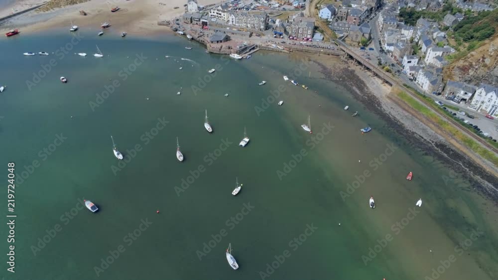 Aerial view, sideways move. Drone panorama over sea, harbor, beach and downtown of Barmouth, Wales