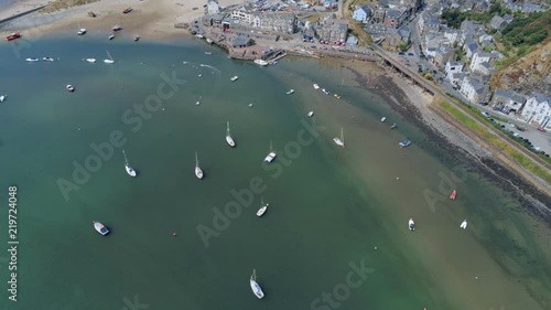 Aerial view, sideways move. Drone panorama over sea, harbor, beach and downtown of Barmouth, Wales