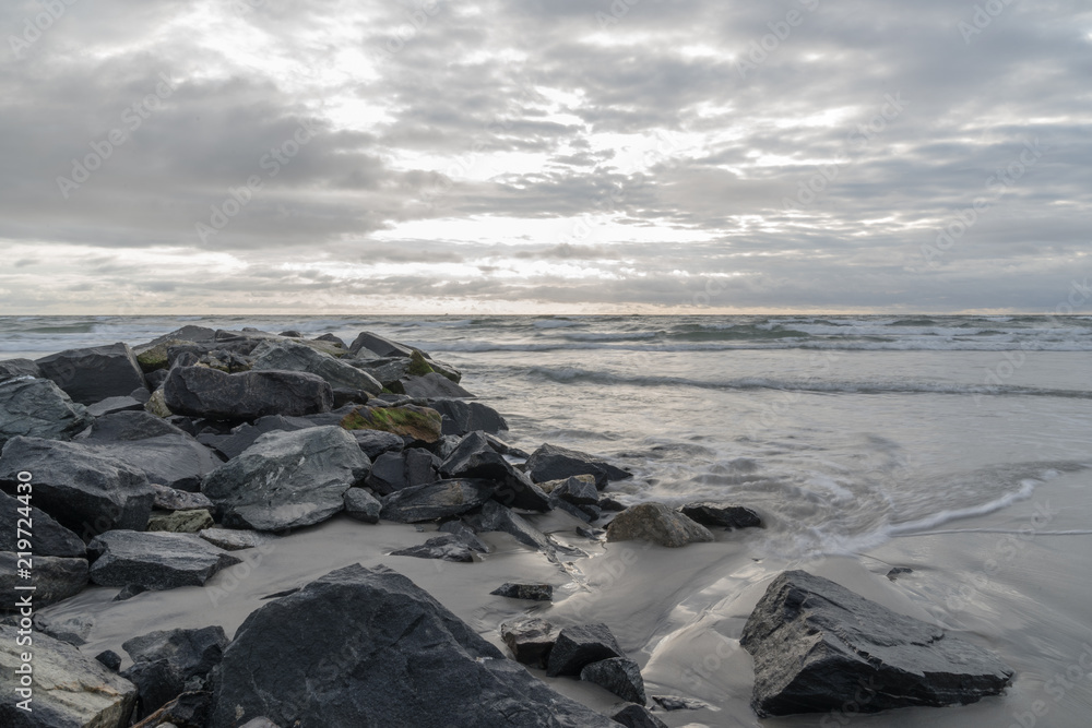 Rockwall in Ocean With Crashing Water at Sunrise Landscape Rockwall in Ocean With Crashing Water at Sunrise Landscape