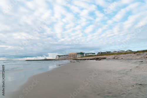 Beautiful Beach and Water in Foreground with Vacation Hotels in Background with cloudy sky