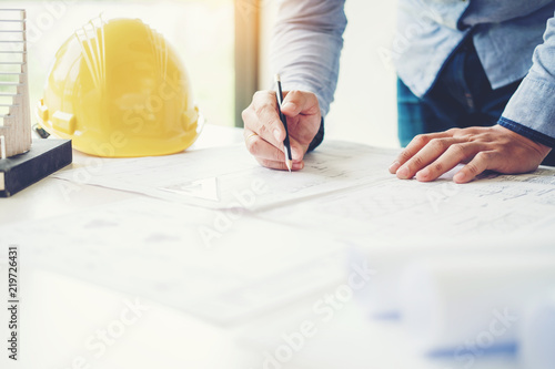 Architect or engineer working in office on blueprint. Architects workplace