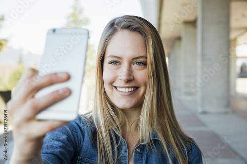 Woman in her twenties taking a selfie or videocalling