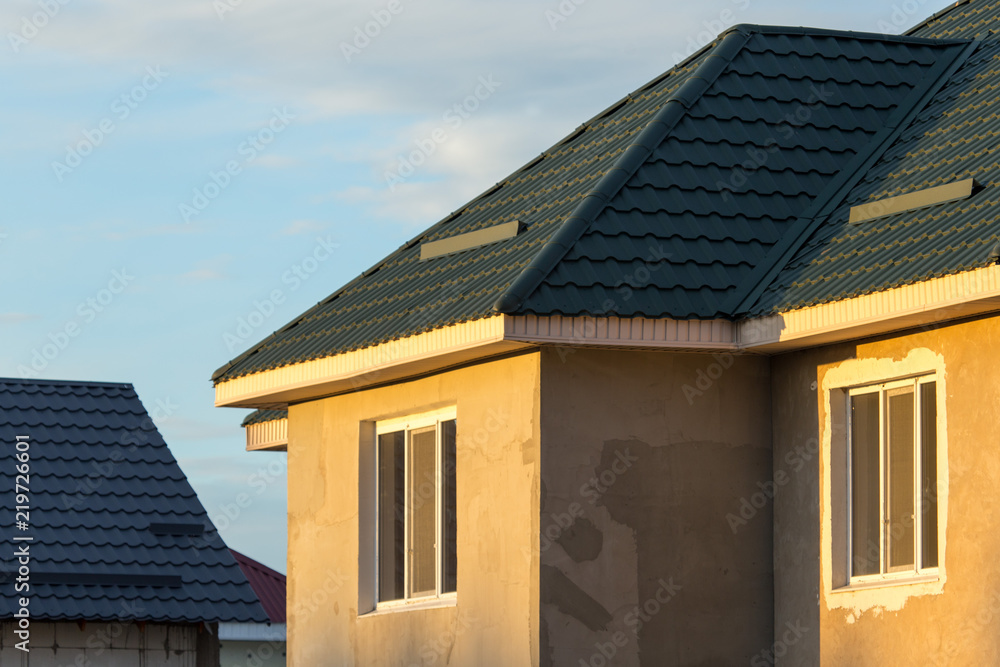 unfinished house and a roof against the blue sky.