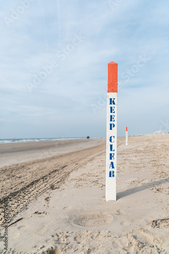 Keep Clear sign post on New Jersey Beach with Blue Sky in Background