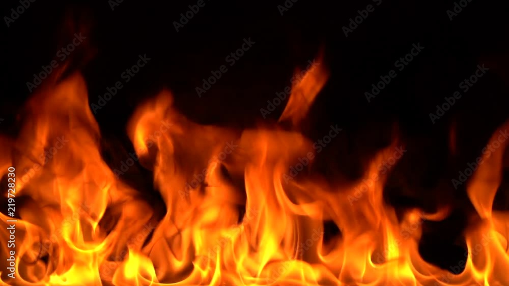 Igniting fire isolated on black background. Detailed real flames tongues. Halloween, hot burning hell, inferno concept. Slow motion. Igniting fire isolated on black background. Detailed real flames tongues. Halloween, hot burning hell, inferno concept. Slow motion.