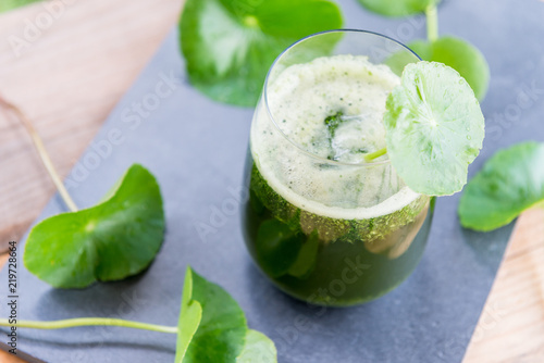 Blended green pennywort , asiatic juice with green background. © teen00000