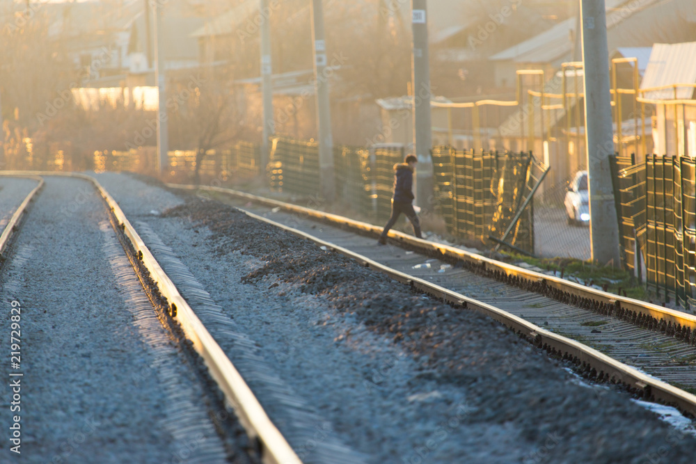 a man crossing a railway