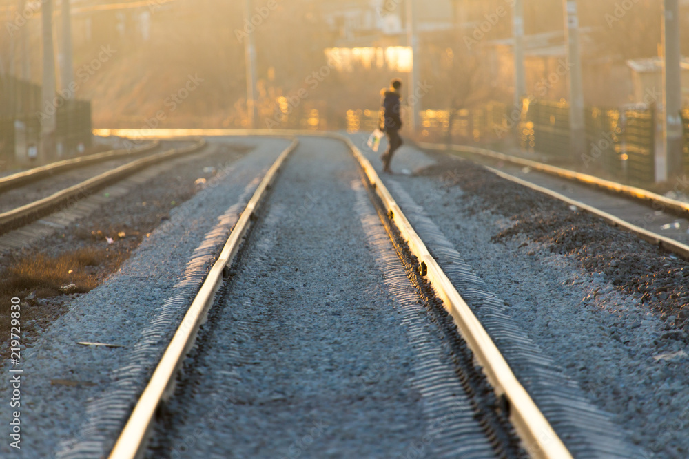 Fototapeta premium a man crossing a railway