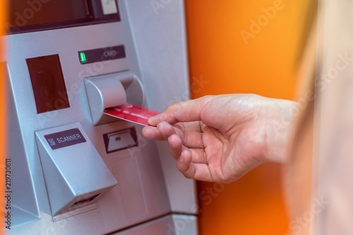 Closeup woman withdrawing the cash via ATM  business Automatic Teller Machine concept