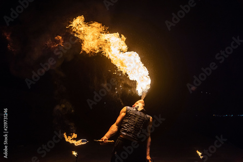 Fire show artist breathe fire in the dark