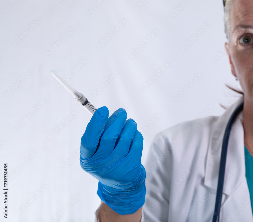 syringe is held up by your doctor to remind you that it is vaccination time
