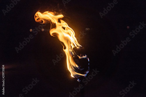 Burning Torch in the Night at black background photo