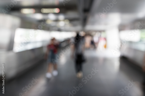 Blur of people crossing pedestrian bridge