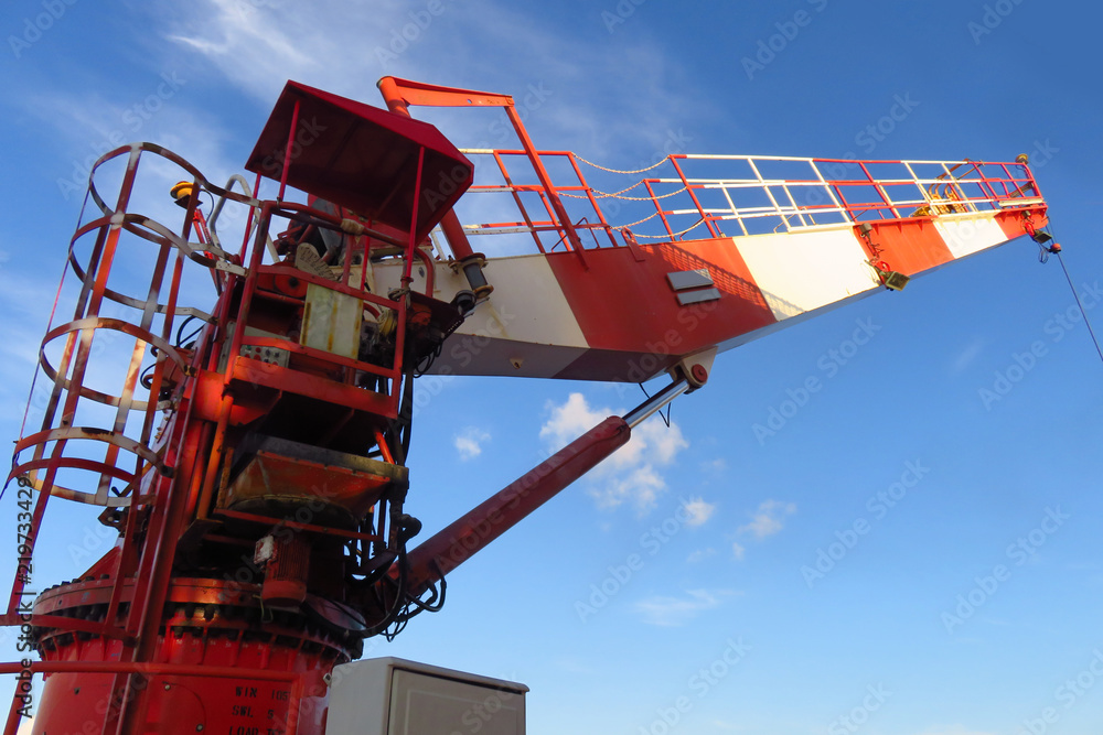 Crane construction on Oil and Rig platform for support heavy cargo. Transfer cargo or basket on work site, Heavy industry, heavy job on the oil and gas platform, Offshore operation on the platform.