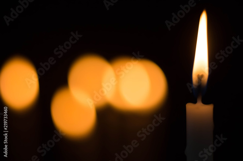 candle burning brightly on bokeh background.