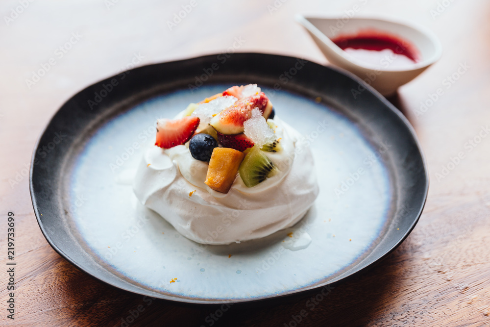 Meringue topping with fresh fruits including strawberry, mango, kiwi, blueberry and common fig served with sour fruit sauce. Meringue topping with fresh fruits including strawberry, mango, kiwi, blueberry and common fig served with sour fruit sauce.