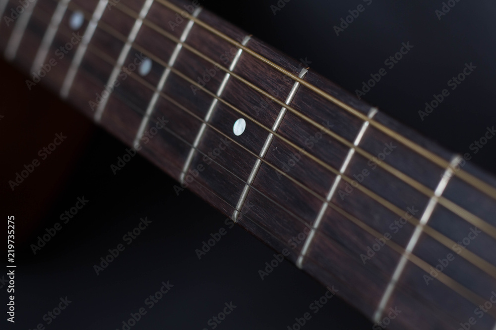 Close up of a guitar neck with strings Close up of a guitar neck with strings