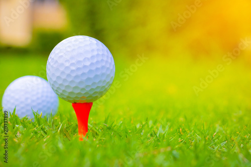 Golf ball on the Course. Golf ball on Orange tee. They are prepare to shot. Photo for health and game. 