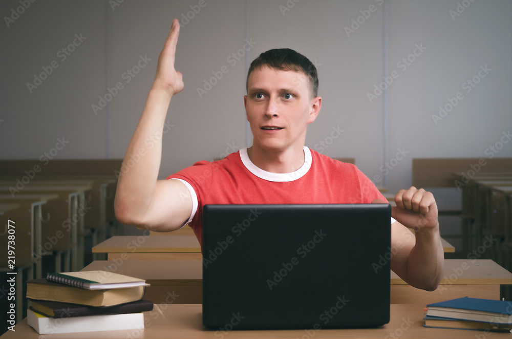 Student is raising his hand and wants to answer the teacher's question. Student is raising his hand and wants to answer the teacher's question.
