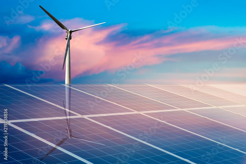 Wind turbines and solar panels closeup on sky background