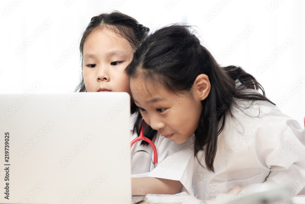 Asian children playing doctor with laptop, kid lifestyle concept. Asian children playing doctor with laptop, kid lifestyle concept.