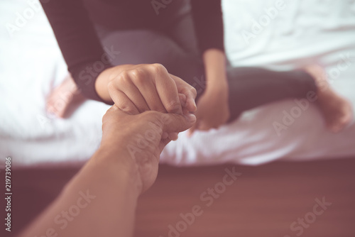 Husband giving hand to depressed wife,Holding hands patient,Mental health care concept