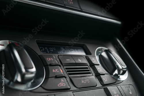 Air conditioning button inside a car. Climate control AC unit in the new car. Modern car interior details. Car detailing. © Aleksei