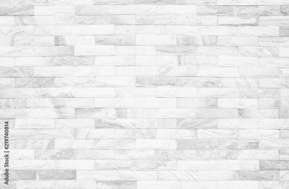 Obraz premium Grey and white brick wall texture background. Brickwork or stonework flooring interior rock old pattern clean concrete grid uneven bricks design stack.