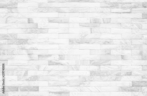 Grey and white brick wall texture background. Brickwork or stonework flooring interior rock old pattern clean concrete grid uneven bricks design stack.