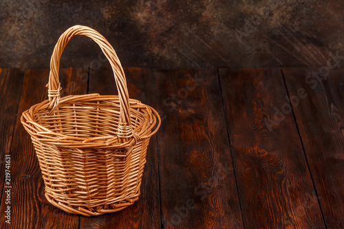 Empty wicker basket on wooden background with copyspace
