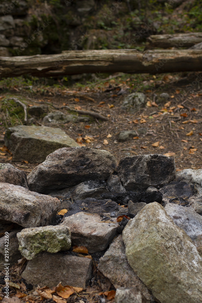 Stone fireplace in the middle of nature. Camping in the wild. Travel under the stars or under a tent in nature.
