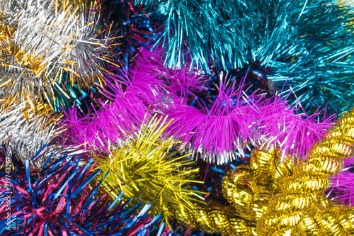 Background of multi-colored Christmas decorations and toys.