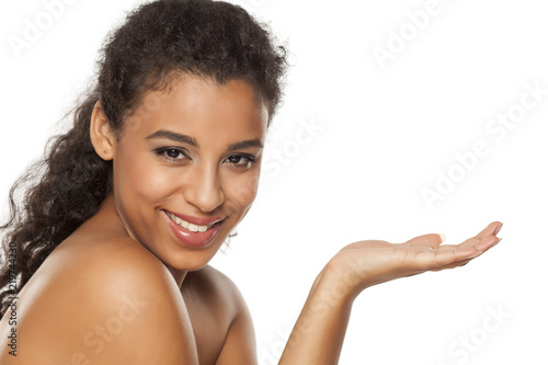 portrait of a young smiling dark-skinned woman on a white background, advertise some product