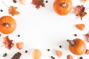Autumn composition. Pumpkins, candles, dried leaves on white background. Autumn, fall, halloween concept. Flat lay, top view, copy space