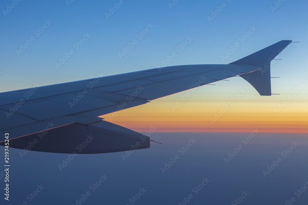 Wing of an airplane in the sunset. Airplane wing out of window. Wing of an airplane in the sunset. Airplane wing out of window.