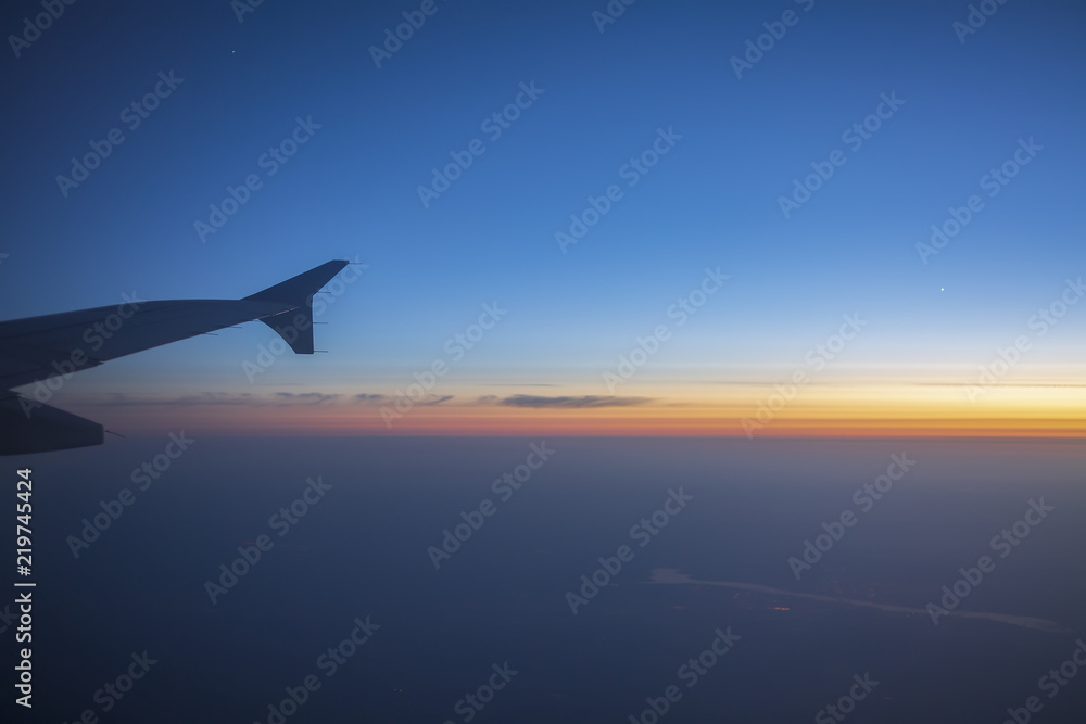 Wing of an airplane in the sunset. Airplane wing out of window. Wing of an airplane in the sunset. Airplane wing out of window.