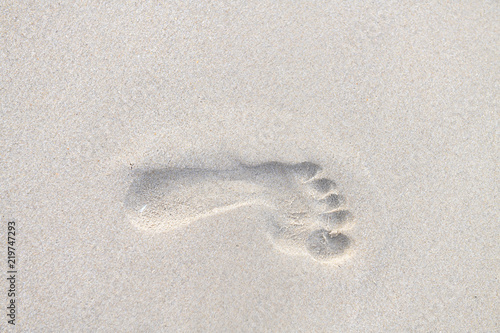 Footprints walking on the beach by the morning, The concept of walking destination