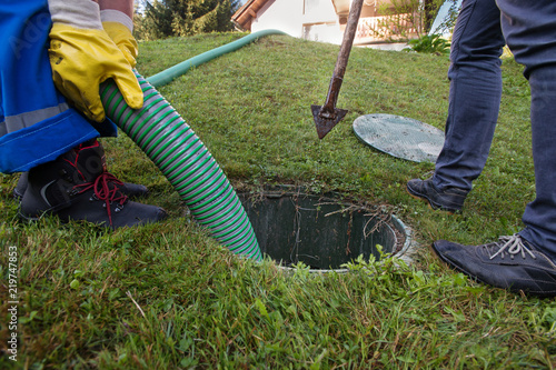 Emptying household septic tank. Cleaning and unblocking clogged drain.
