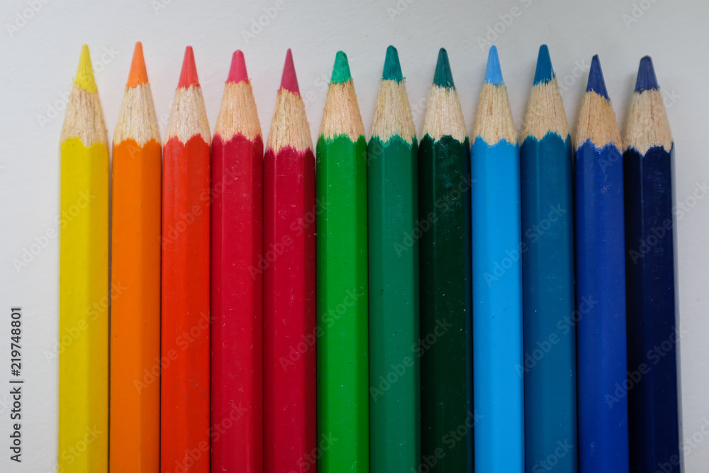 Close up of 12 colored pencils in a row Close up of 12 colored pencils in a row
