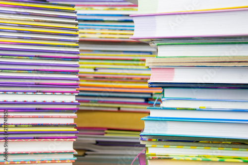 Two piles of colorful books.