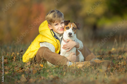 Child with dog in autumn 