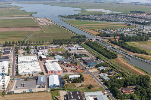 Aerial view beach Dutch village Lemmer with industrial park, lake, sluice, canal, and marina harbor photo