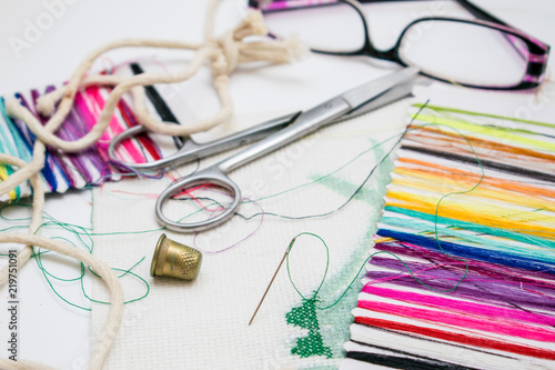 Set for embroidery: multi-colored thread, canvas, scissors.
