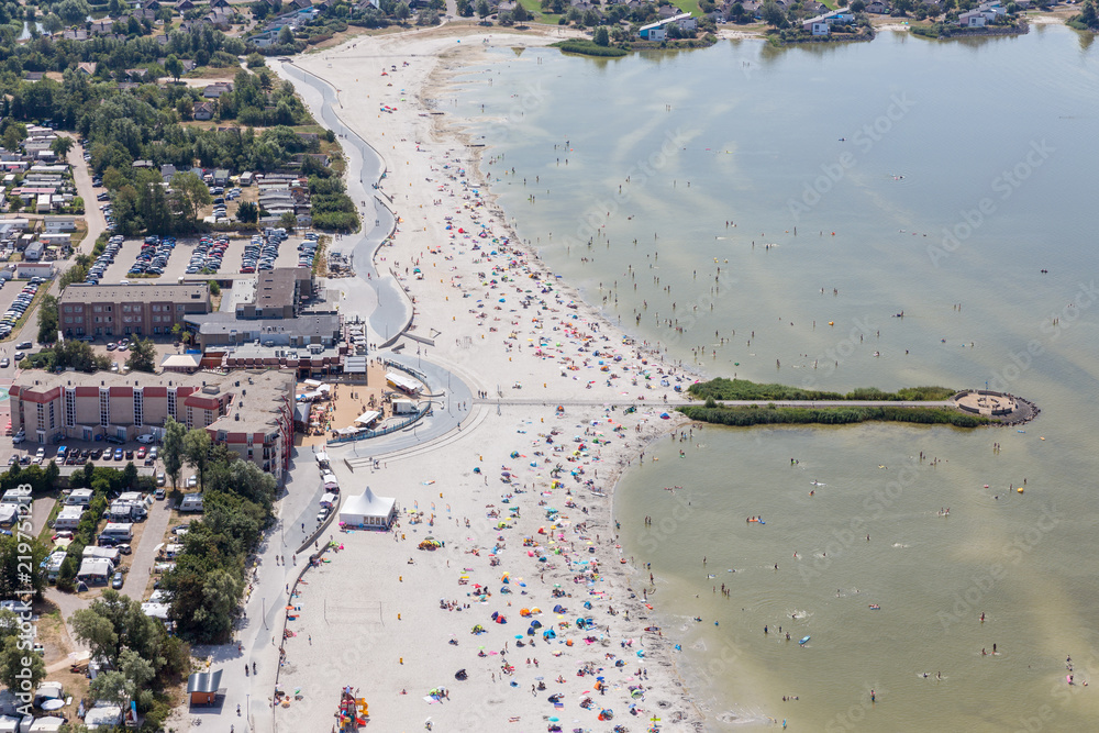 Aerial view Dutch village Makkum in Friesland with beach and swimming people