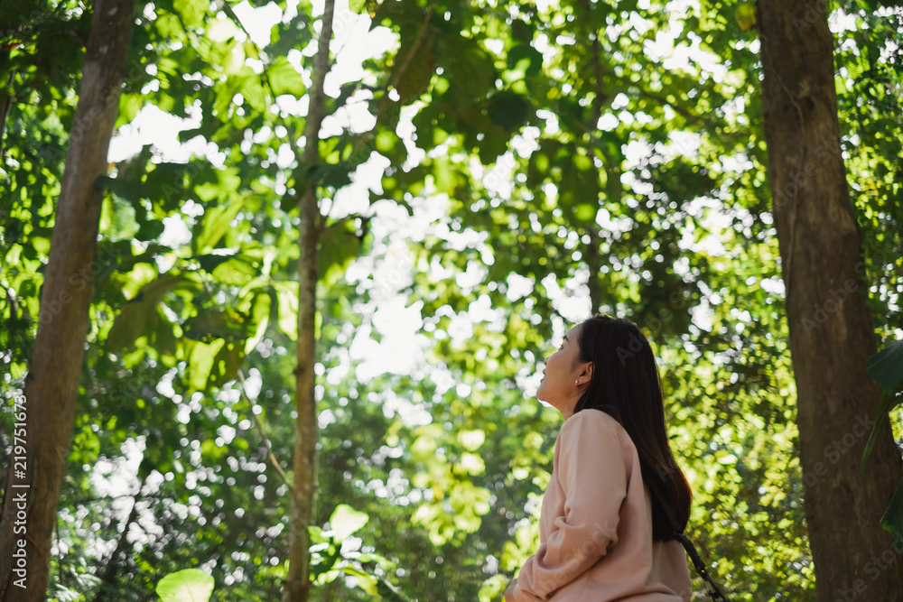 Asian beautiful woman relax in green nature forest