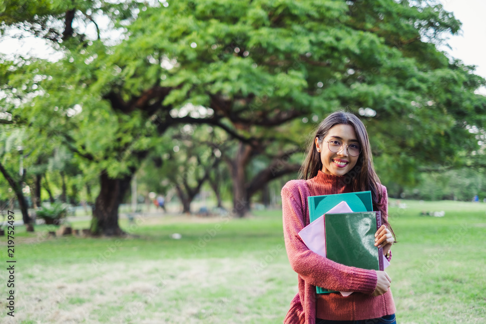 Fototapeta premium portrait asian young teen student standing in park for studying and education concept