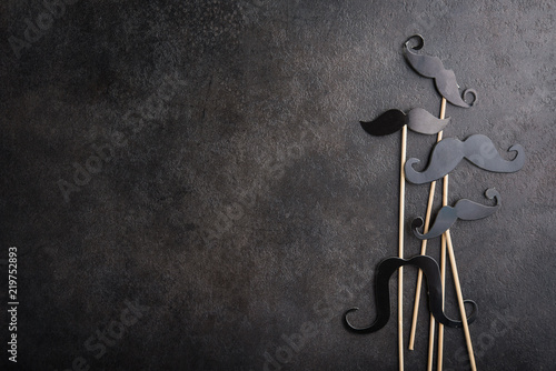 Black photo booth man mustache on a stone background