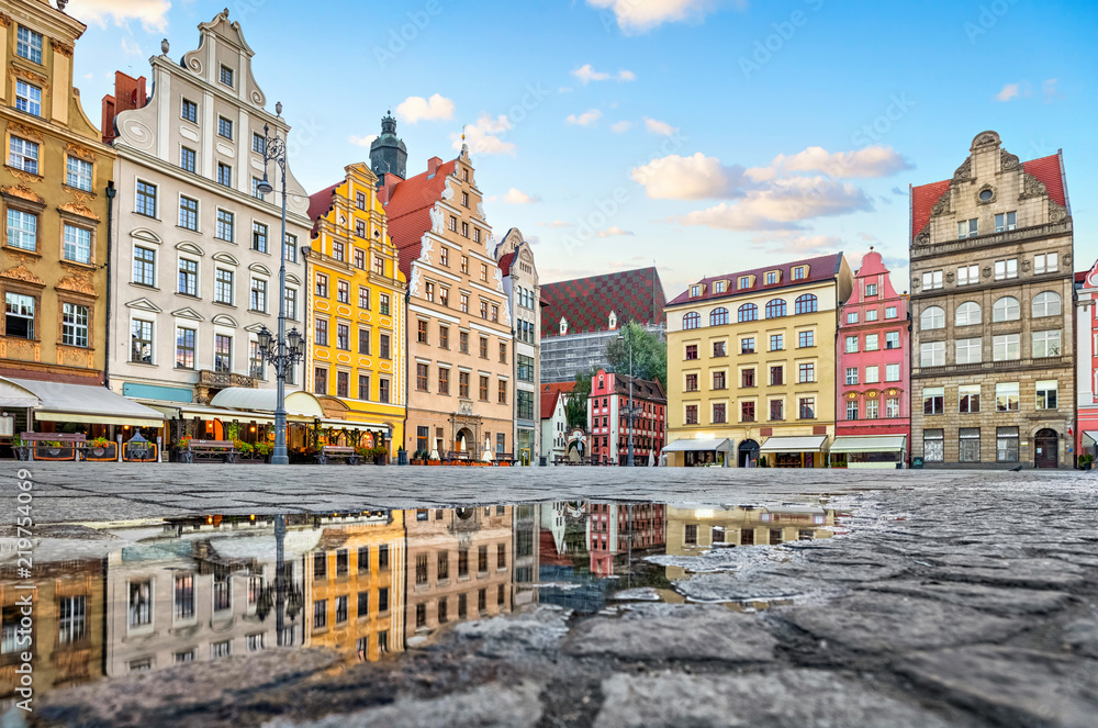 Old colorful buildings reflecting in a puddle on Rynek square in Wroclaw, Poland